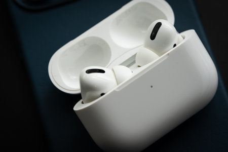 Apple Airpods Pro isolated on wooden surface. The new airpods pro features active noise cancelling and customizable fitのeditorial素材