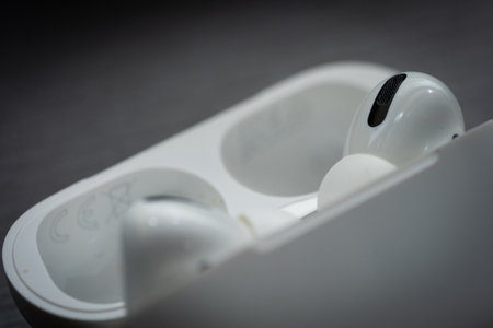 Apple Airpods Pro isolated on wooden surface. The new airpods pro features active noise cancelling and customizable fitのeditorial素材
