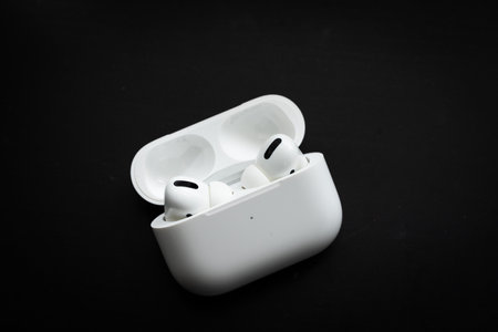 Apple Airpods Pro isolated on wooden surface. The new airpods pro features active noise cancelling and customizable fitのeditorial素材