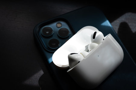 Apple Airpods Pro isolated on wooden surface. The new airpods pro features active noise cancelling and customizable fitのeditorial素材