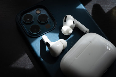 Apple Airpods Pro isolated on wooden surface. The new airpods pro features active noise cancelling and customizable fitのeditorial素材