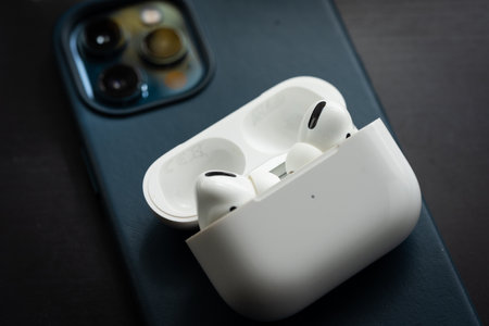 Apple Airpods Pro isolated on wooden surface. The new airpods pro features active noise cancelling and customizable fitのeditorial素材