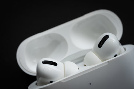 Apple Airpods Pro isolated on wooden surface. The new airpods pro features active noise cancelling and customizable fitのeditorial素材