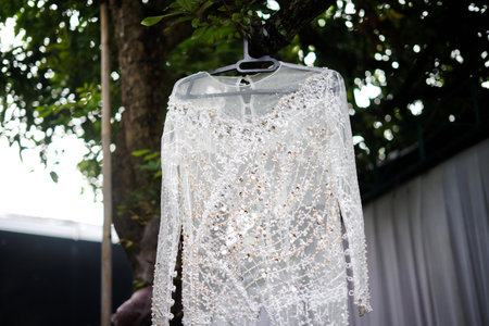 Wedding dress hanging on a hanger in the garden.