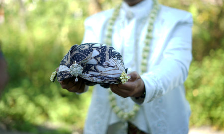 wedding dress and accessories in hands of the bride and groom