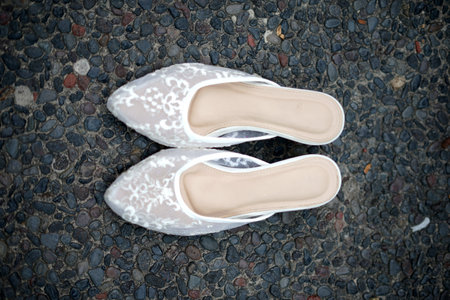 Pair of white shoes on the ground, vintage color tone.