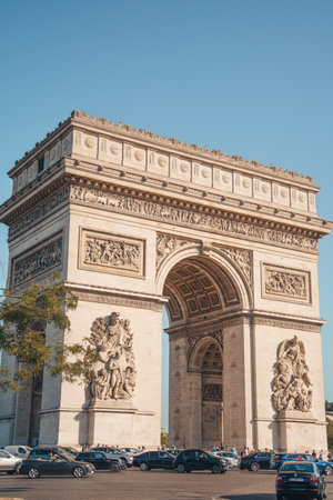 Portrait close view of famous iconic Arc de Triomphe with soft blue sky monument at the western end of the Champs-Elysees road in Paris, France-08.22.2019のeditorial素材