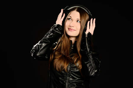 Young woman with big headphones enjoying good musicの写真素材