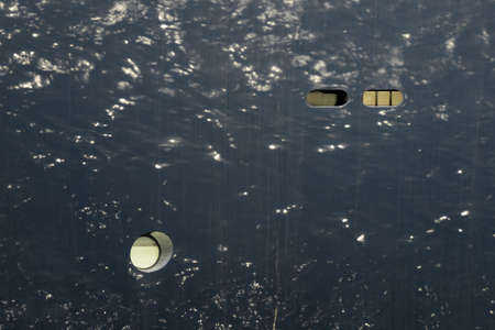 Sea reflecting at a blue boat