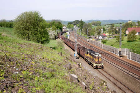 Old diesel cargo locomotive with empty coal rail carsの写真素材