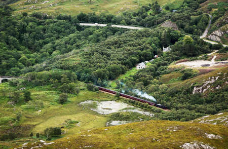 Touristic old train with steam locomotive in scottish countrysideの写真素材