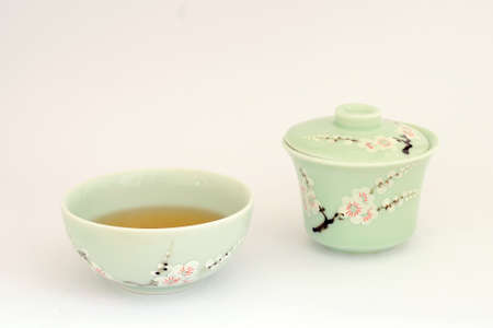 Green tea cup and tea bowl with chinese hand-painted decorationsの写真素材