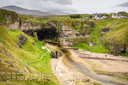 Smoo cave in the north of Scotland, taken from the top on a very rainy dayの写真素材