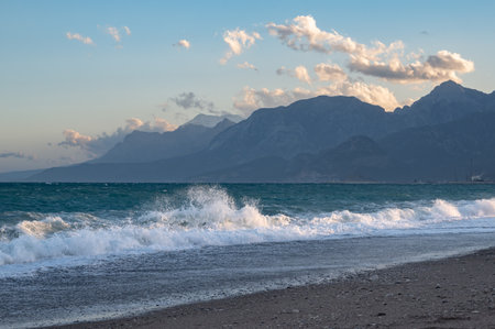 Waves on Konyaalti beach with mountains covered in snow in the background, Antalya, Turkeyの写真素材