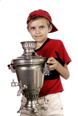 the boy with a samovar in the shadow of leaves grapes.の写真素材