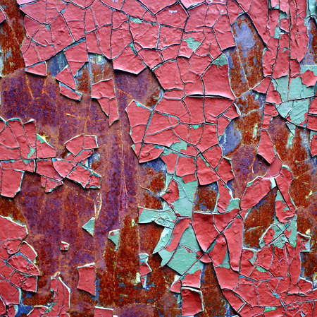 rusty iron sheet with corrosion steins and the cracked paint.