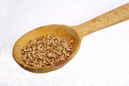 buckwheat groats in a wooden spoon.の写真素材