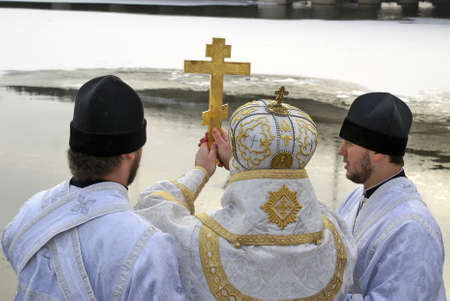 celebraty service on river Psel priest on the Sumy  catedral Ukraine spend in holiday Christenings...
