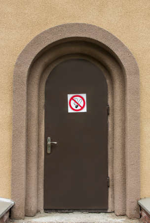 With a precantionary sign   to Smoke a door it is forbidden 