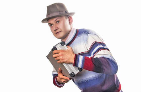 The hurrying up man in a grey hat の写真素材