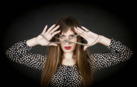 The woman looks through silver a chain.の写真素材