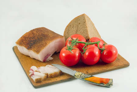 Red tomatoes,fat,bread.の写真素材