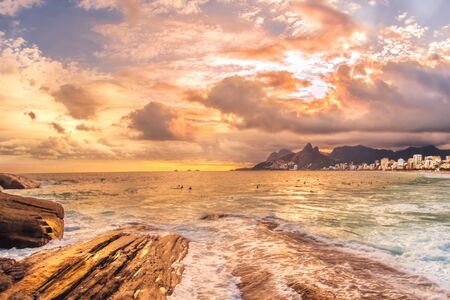 Golden light shot from the sun against the sea against the rocks.の写真素材