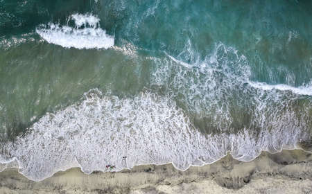 Wave of the sea on the sand beachの写真素材