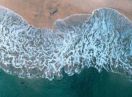 Wave of the sea on the sand beachの写真素材