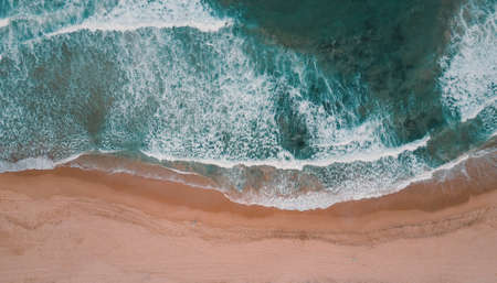 Wave of the sea on the sand beachの写真素材