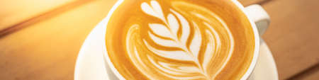 Closeup food and drink of hot coffee latte on dark wooden table with copy space using as background food cover page, coffee day concept.の写真素材