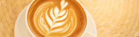 Closeup food and drink of hot coffee latte on dark wooden table with copy space using as background food cover page, coffee day concept.の写真素材