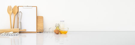 Banner with simple ingredients and kitchen tool on white table. White wall.Modern wooden kitchen table background. cooking at home Mockup.horizontal Panorama cover and header web Banner. Copy space.の写真素材