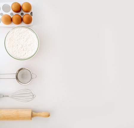 Frame of food ingredients for baking on a gently pink pastel background. Cooking flat lay with copy space. Top view. Baking concept. Mockup.の写真素材