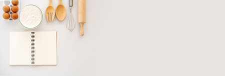 Baking background. Cooking simple ingredients for cookies dough, eggs, flour, rolling pin wisk wooden utensils on pink background.Top view. Flat lay. Copy space. Bannerの写真素材