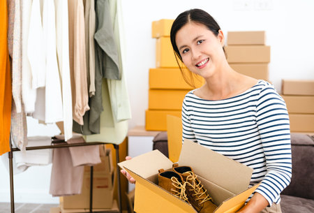 Asian small business owner at home office, on line marketing packaging boxes and delivery, SME concept. Young Owner People Start up for Business Online, SME, Delivery Project.の写真素材