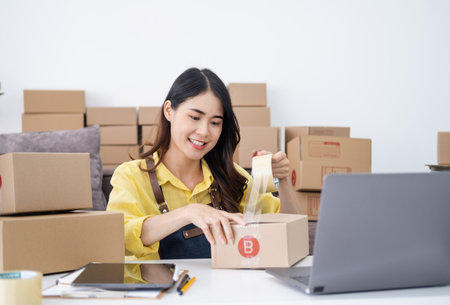 Small Entrepreneurs Start A Home Business By Arranging Goods With Brown Parcel Boxes, Small Home Business Startup Ideas.の写真素材