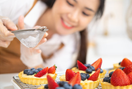 Young beautiful woman is baking in kitchen , bakery and coffee shop business. Freshly baked tart...