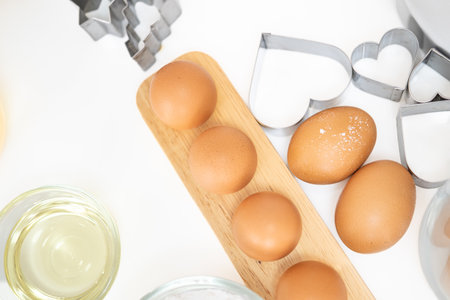 Baking Cooking Ingredients Flour Eggs cookies cutter  Butter And Kitchen Textile On white mable Background. Top View Copy Space. Cookies Pie Or Cake Recipe Mockupの写真素材