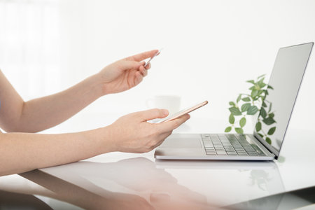 Online shopping concept, woman hands holding mobile phone  and credit card. Woman hands using...