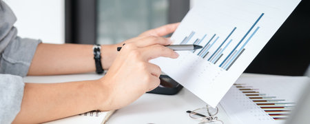 asian business man working with hand pointing graph discussion and analysis data charts and graphs...