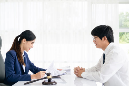 Client in law office Judge gavel with lawyers, Businessman in suit or lawyer working with legal law documents. advice and justice law firm concept.の写真素材