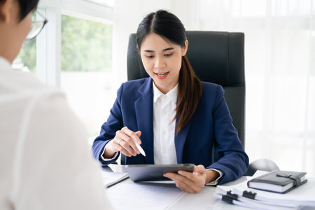 lawyer having meeting and consoling solution to her clients provide legal advice and trust commitment strain serious for problem, justice and attorney conceptの写真素材