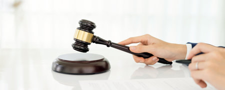 Closeup, lawyer and gavel of judge in office of trial, attention and meeting for justice in...