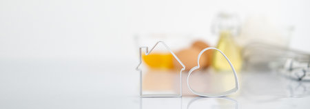 Bakery products.Dessert ingredients and utensils on white reflect table background . Web Banner Front view. Copy space. egg, flour, milk, oil, Whisk, cookies cutter.の写真素材