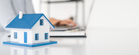 Sales manager or real estate agent will be prepared to show you a sample home and detail the terms of buying a home with insurance promotions, Attention to property services and insurance concept.の写真素材