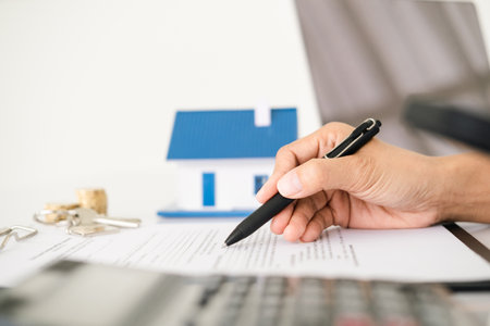 House model with real estate agent and customer discussing for contract to buy house, insurance or loan real estate background.の写真素材