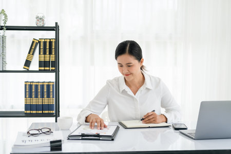 smiling beautiful business asian woman working in office use computer with copy space. Business owner people sme freelance online marketing e-commerce telemarketing, work from home conceptの写真素材
