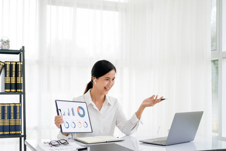 Business video conferencing. Young woman having video call via computer in the home office.