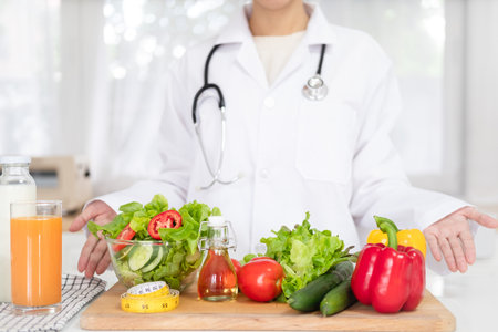nutritionist showing healthy vegetables in the consultation.の写真素材